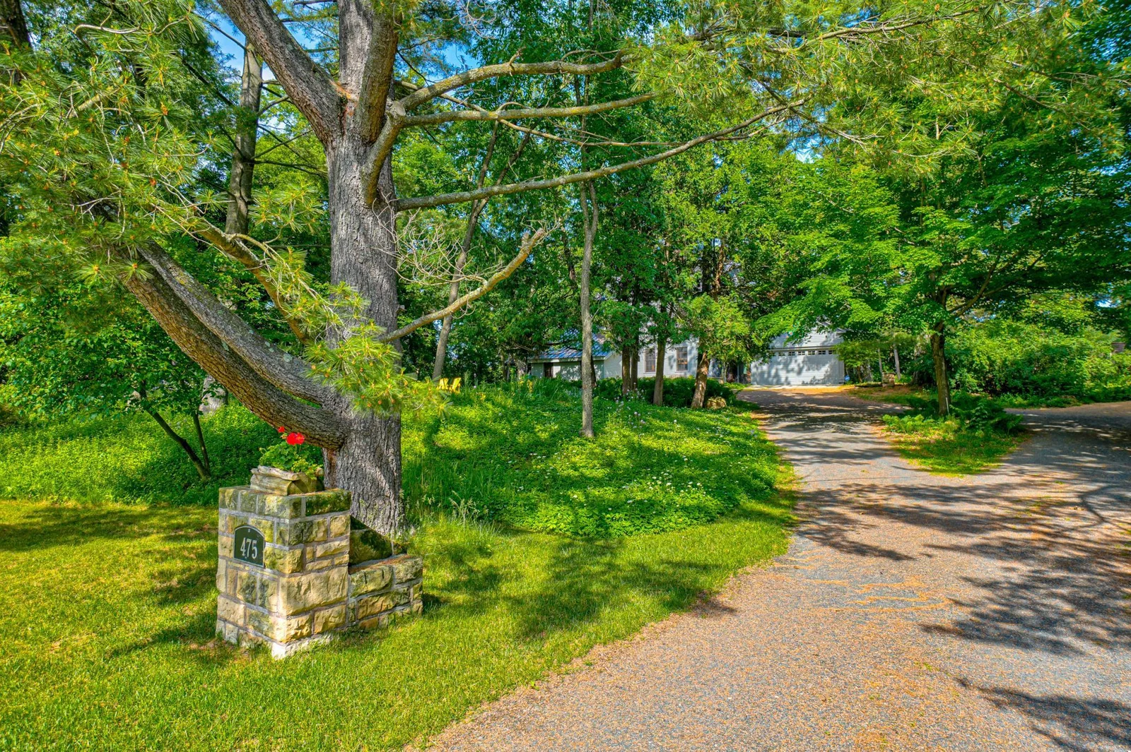 The welcoming stone marker at the end of the paved driveway.