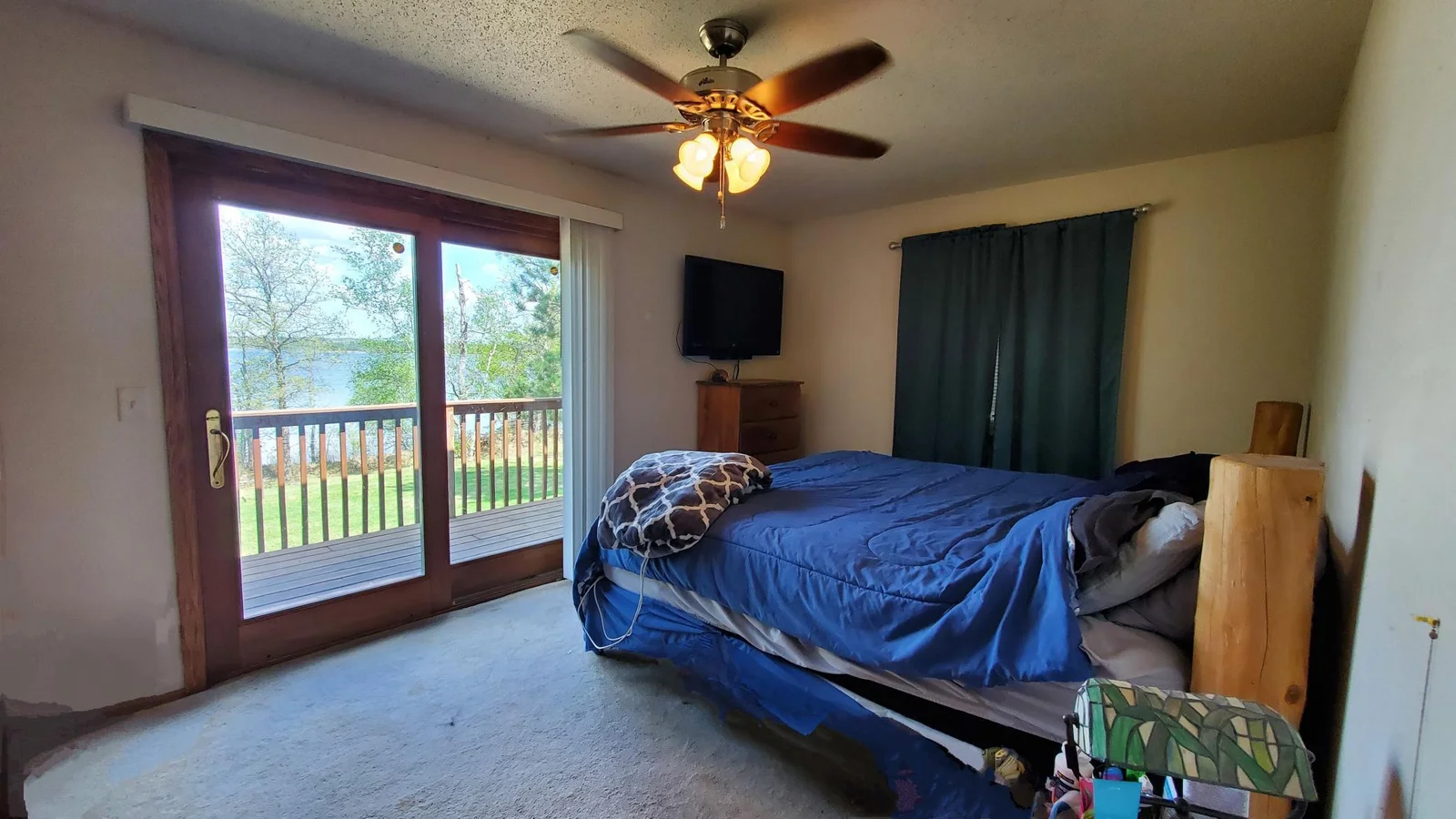 Large bedroom with door to deck