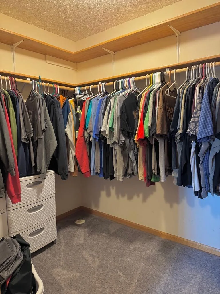 Primary bedroom walk in closet