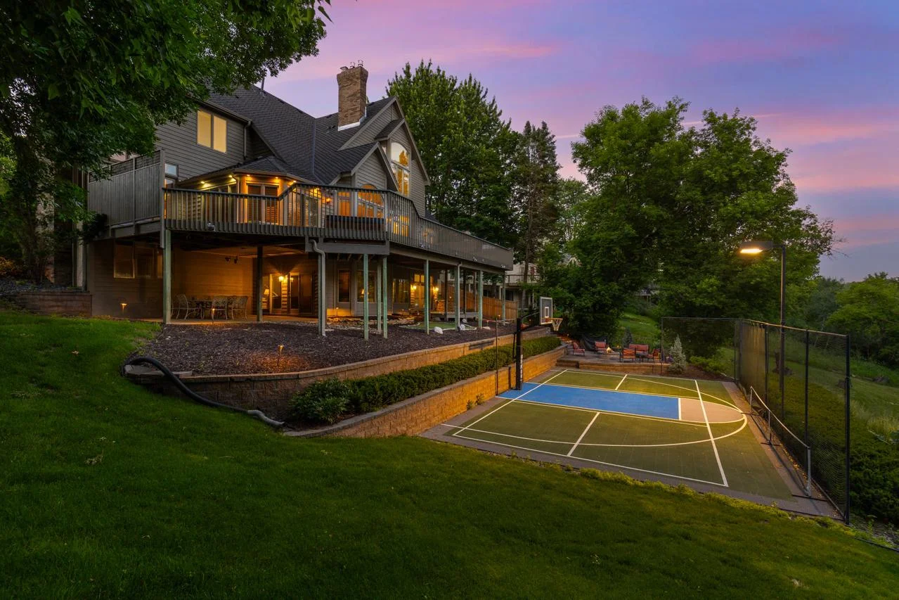 The backyard features a sports court—perfect for basketball, pickleball, and active outdoor fun.