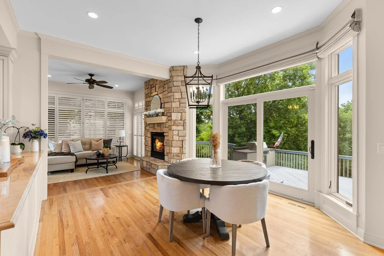 Oversized windows bring in abundant natural light and offer panoramic wooded views.
