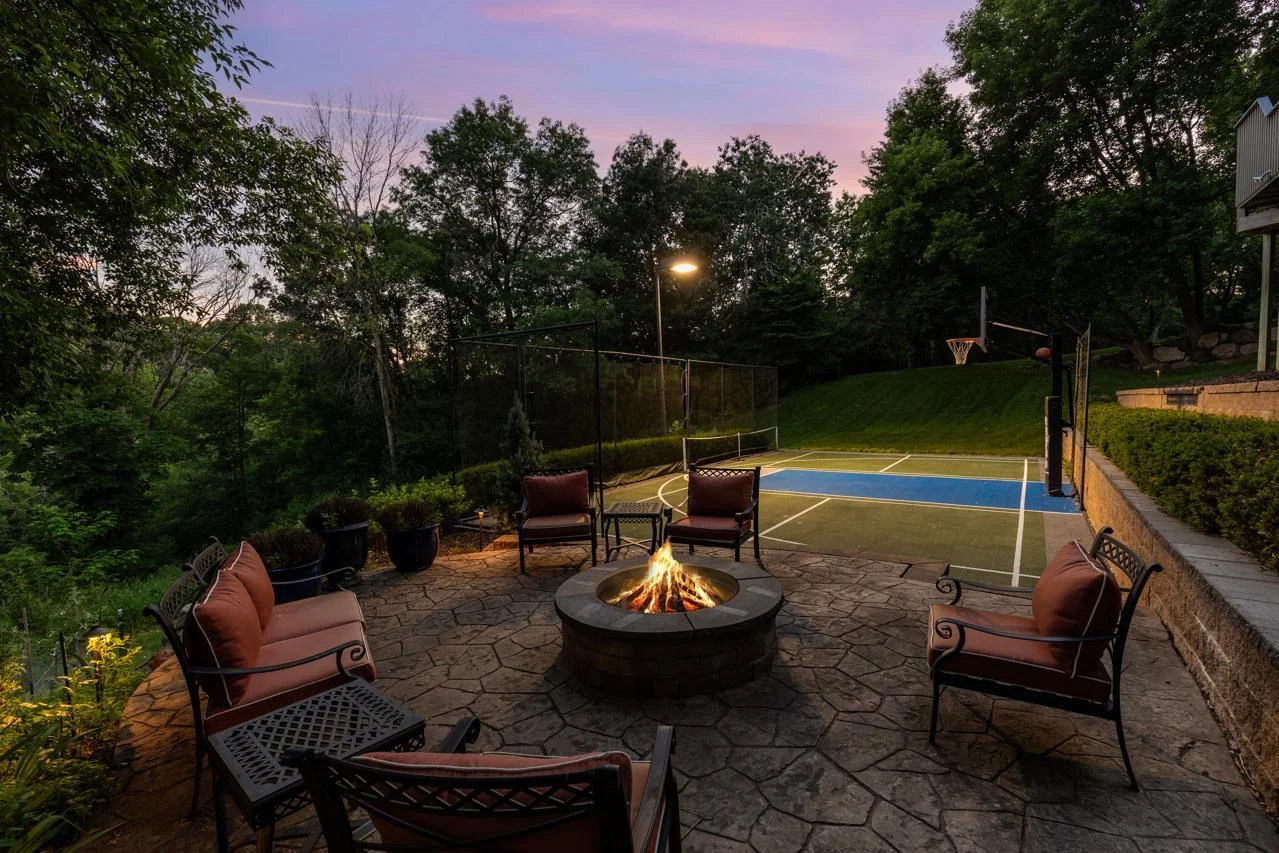 The outdoor fireplace area offers a cozy retreat perfect for relaxing or entertaining.