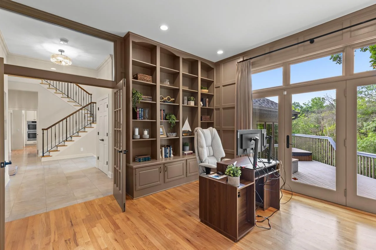 Large main floor office with built-ins and private access to the deck.
