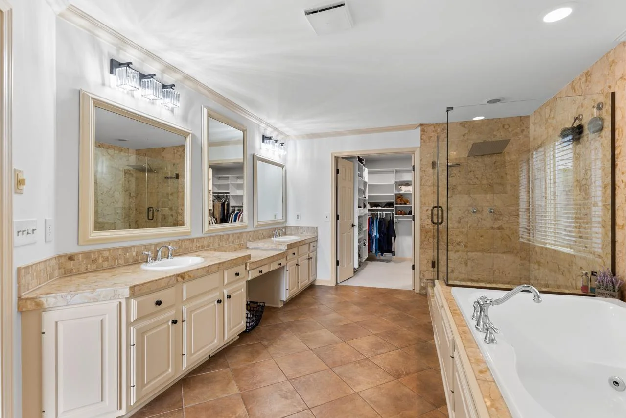 Spa-like ensuite with soaking tub, separate shower, and double vanity