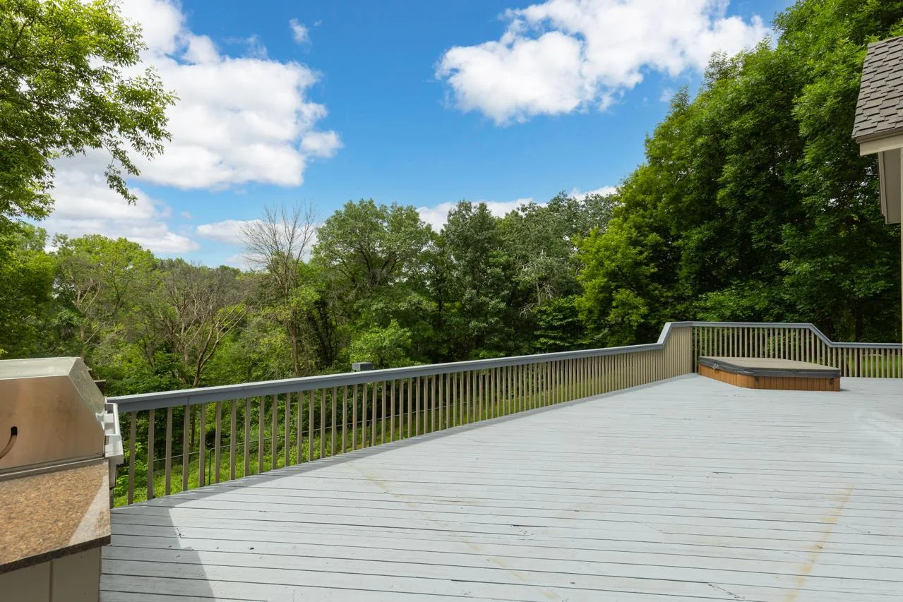 Enjoy stunning views of the surrounding trees from your spacious wrap-around deck, complete with a hot tub