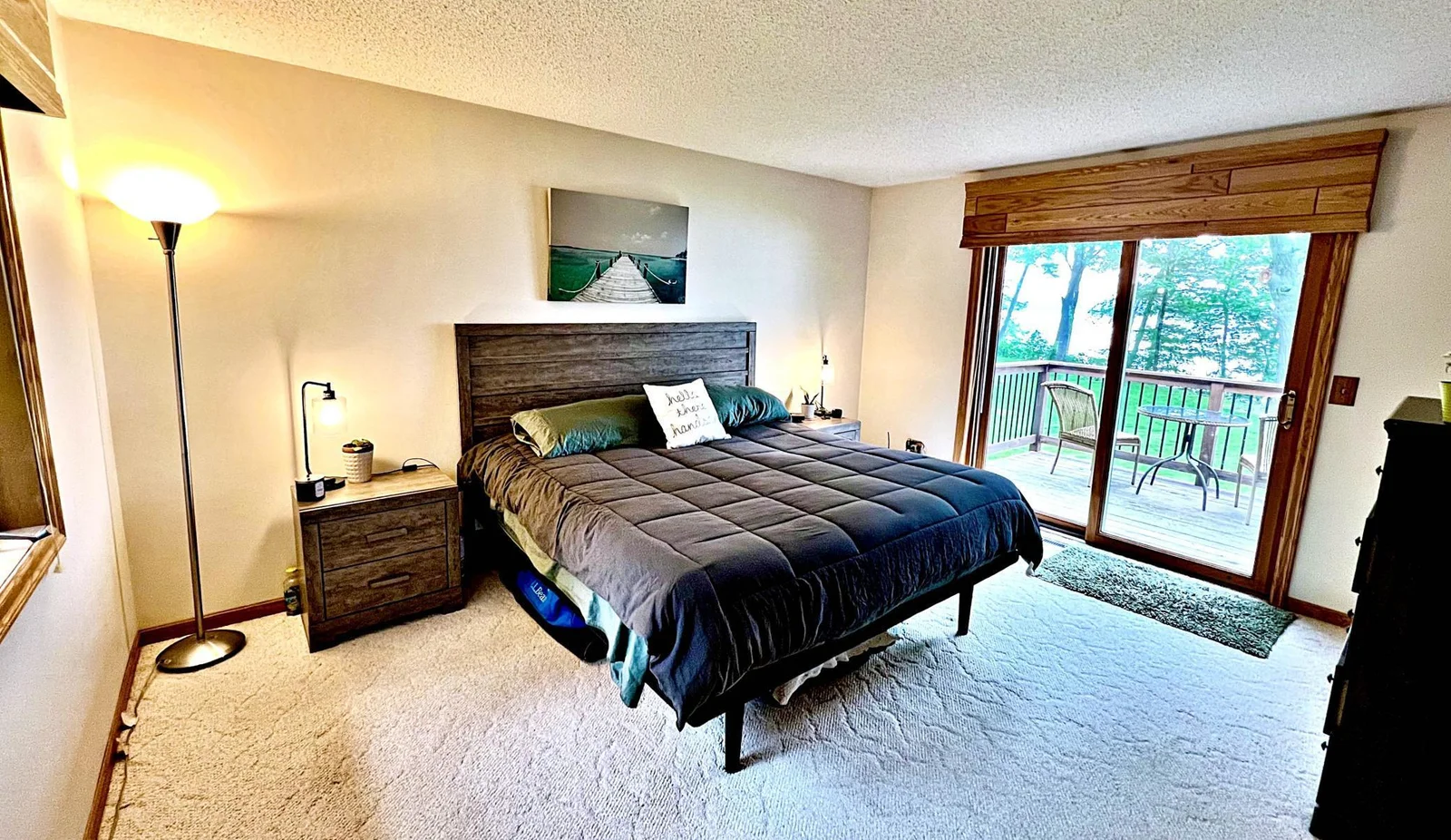 Primary Bedroom with sliding doors to deck and lake views.jpg
