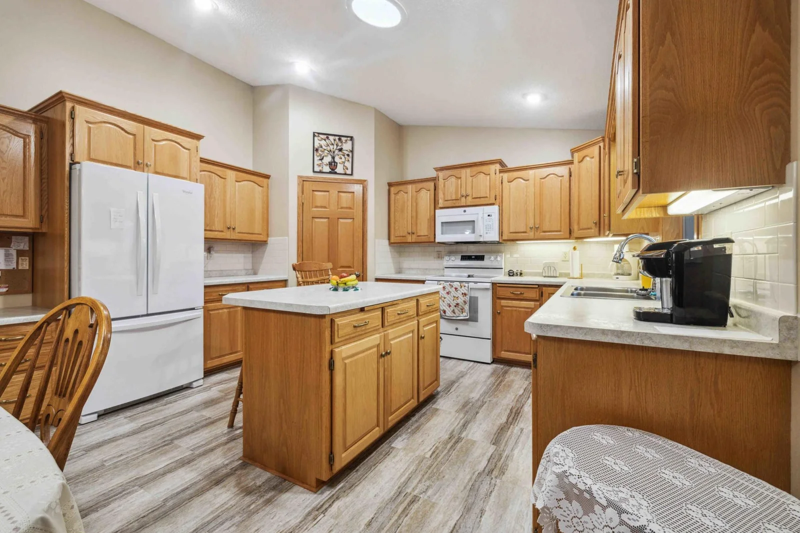 Kitchen has plenty of cabinets for storage plus a corner pantry