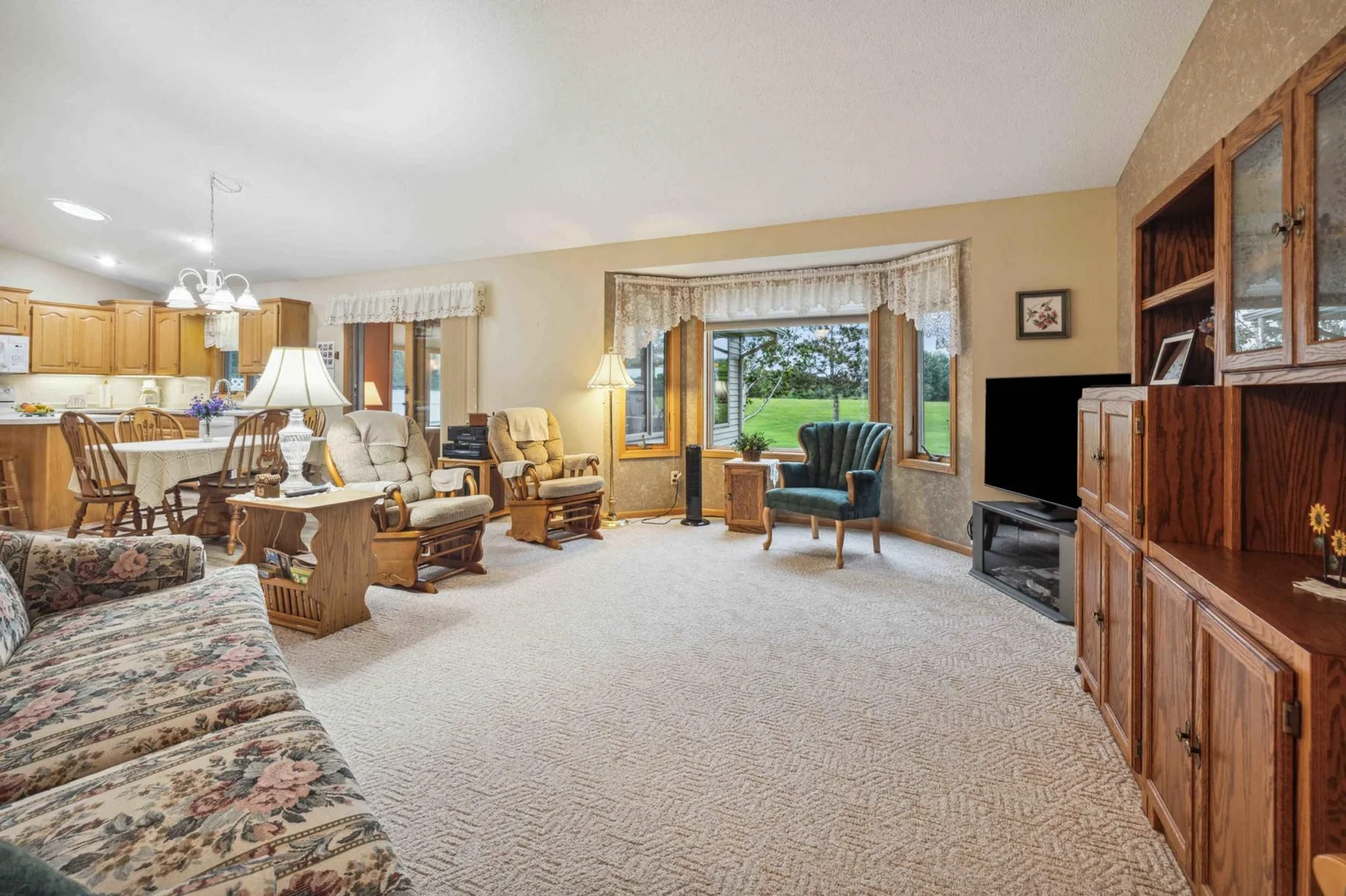 Living room is spacious with open floor plan into kitchen and dining areas