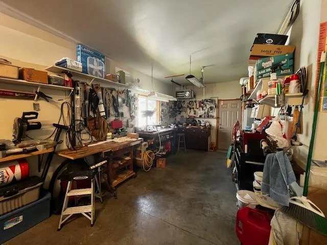 Heated workshop area in the garage has door to back yard