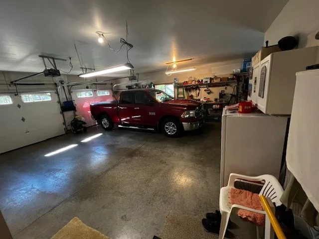 Oversized two stall garage is heated with workshop area