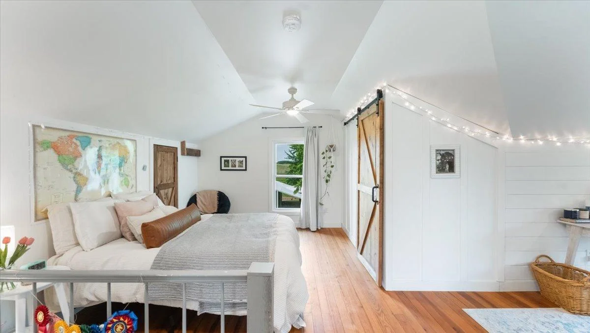 The upstairs bedroom features fir hardwood floors, double walk-in closets, and a private ensuite bathroom.