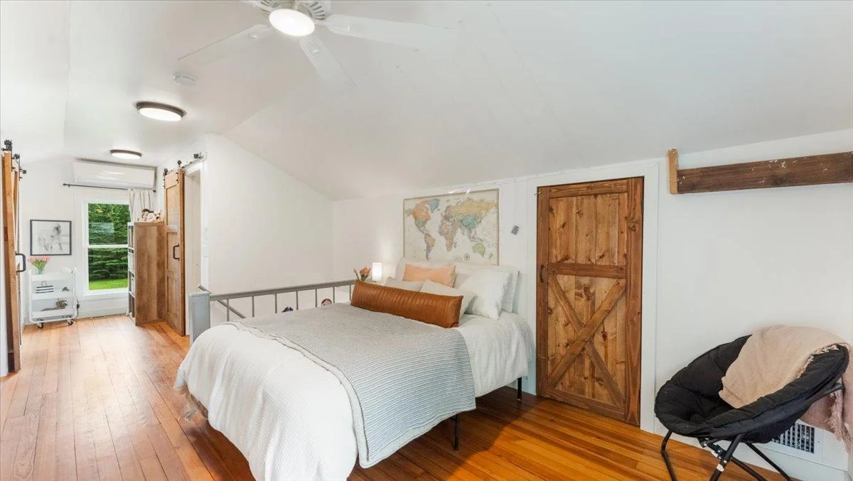 The upstairs bedroom features fir hardwood floors, double walk-in closets, and a private ensuite bathroom.