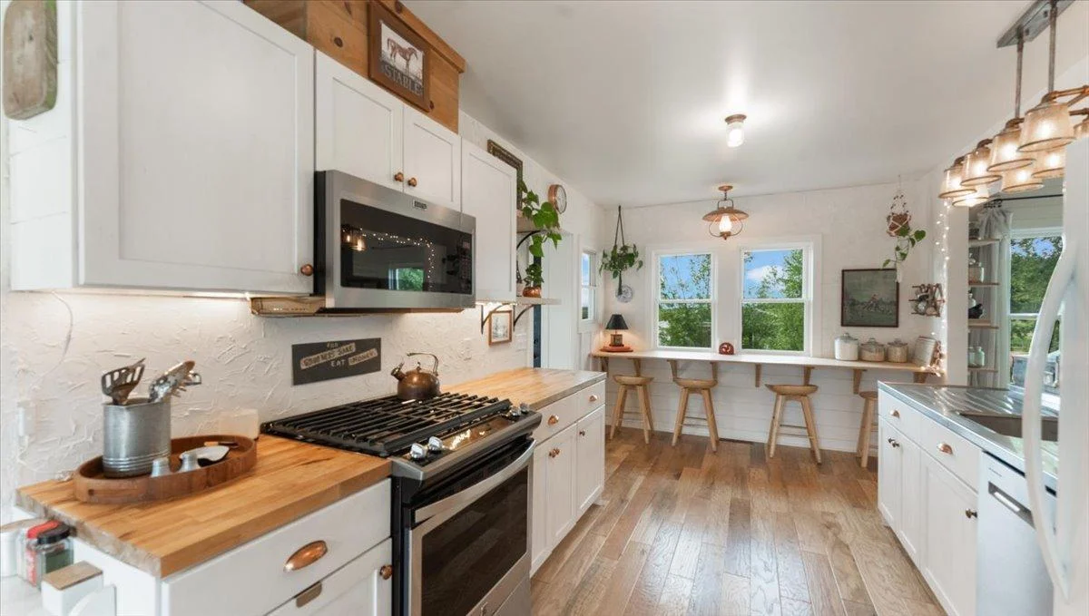 Kitchen features a S.S. gas range and butcher block countertops.