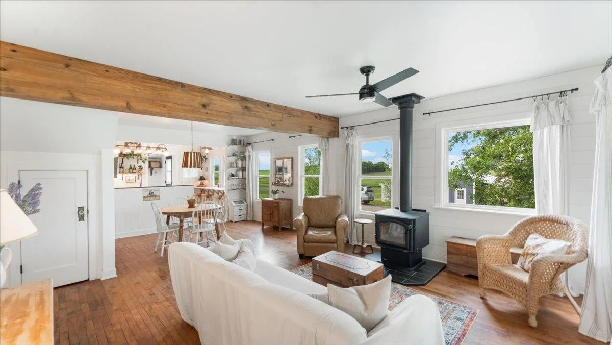 The open concept main floor features original maple hardwood flooring.