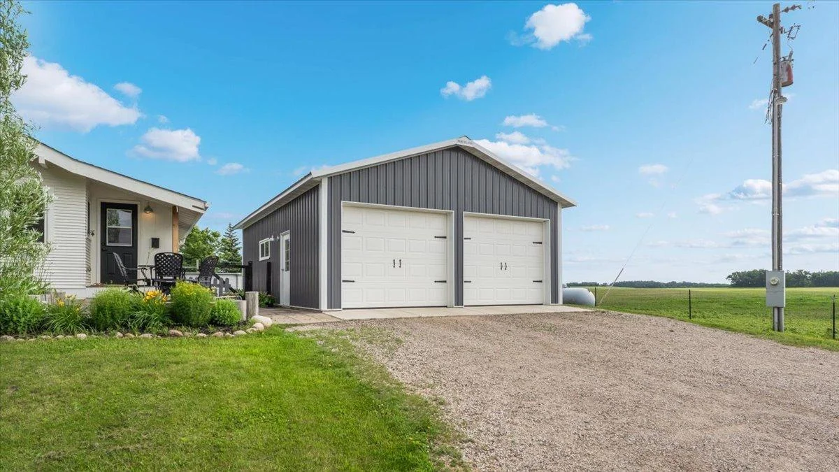 24'x32' two-car garage built in 2020 includes an additional side garage door for a tractor.