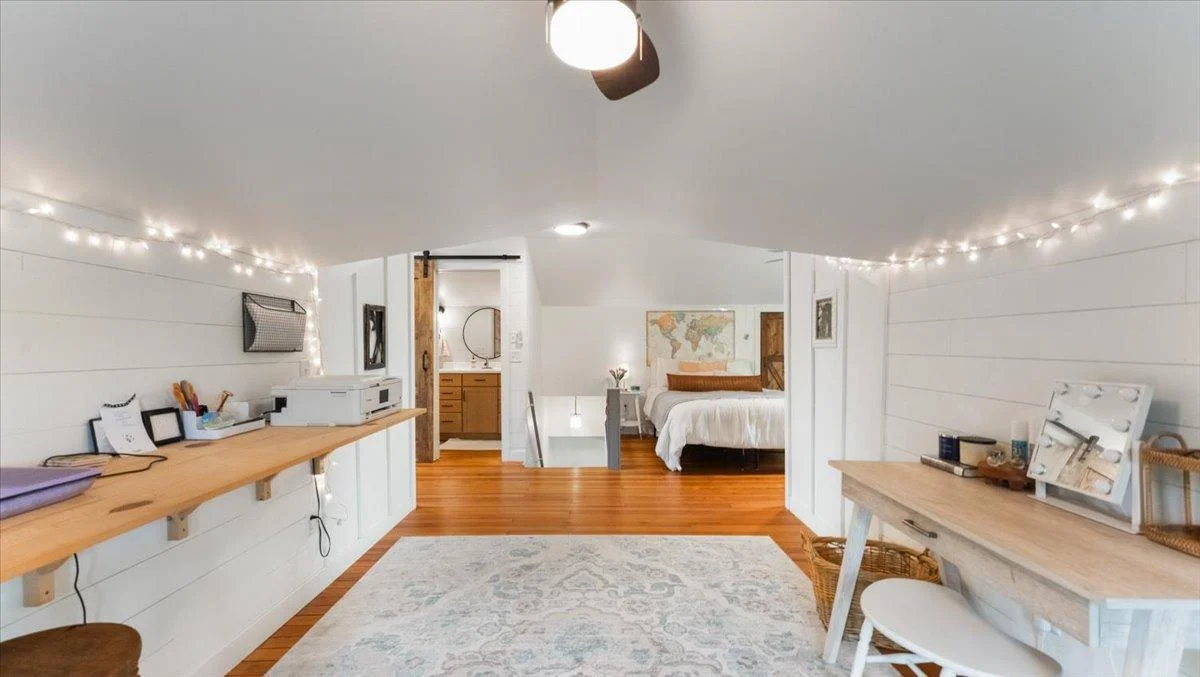 The bedroom features a sitting area with a built-in desk.