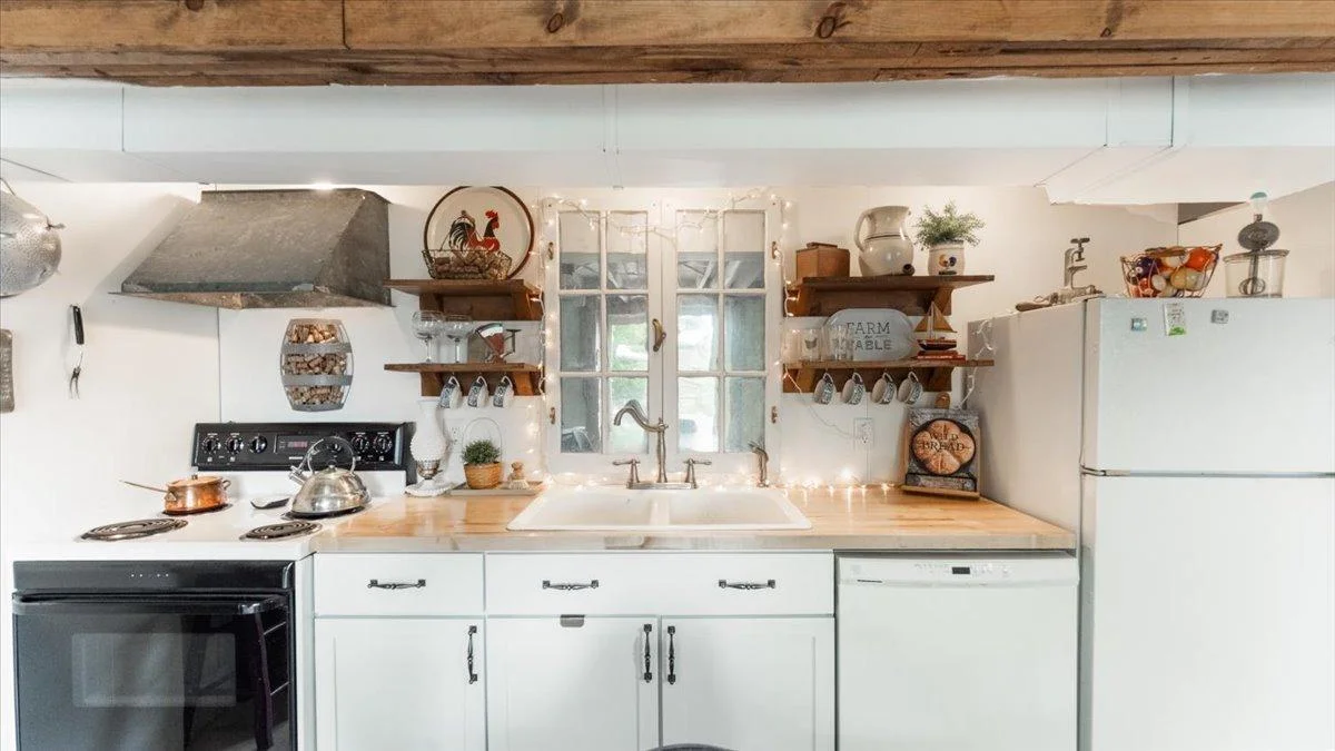 Kitchenette features a range, dishwasher, and full sized refrigerator.