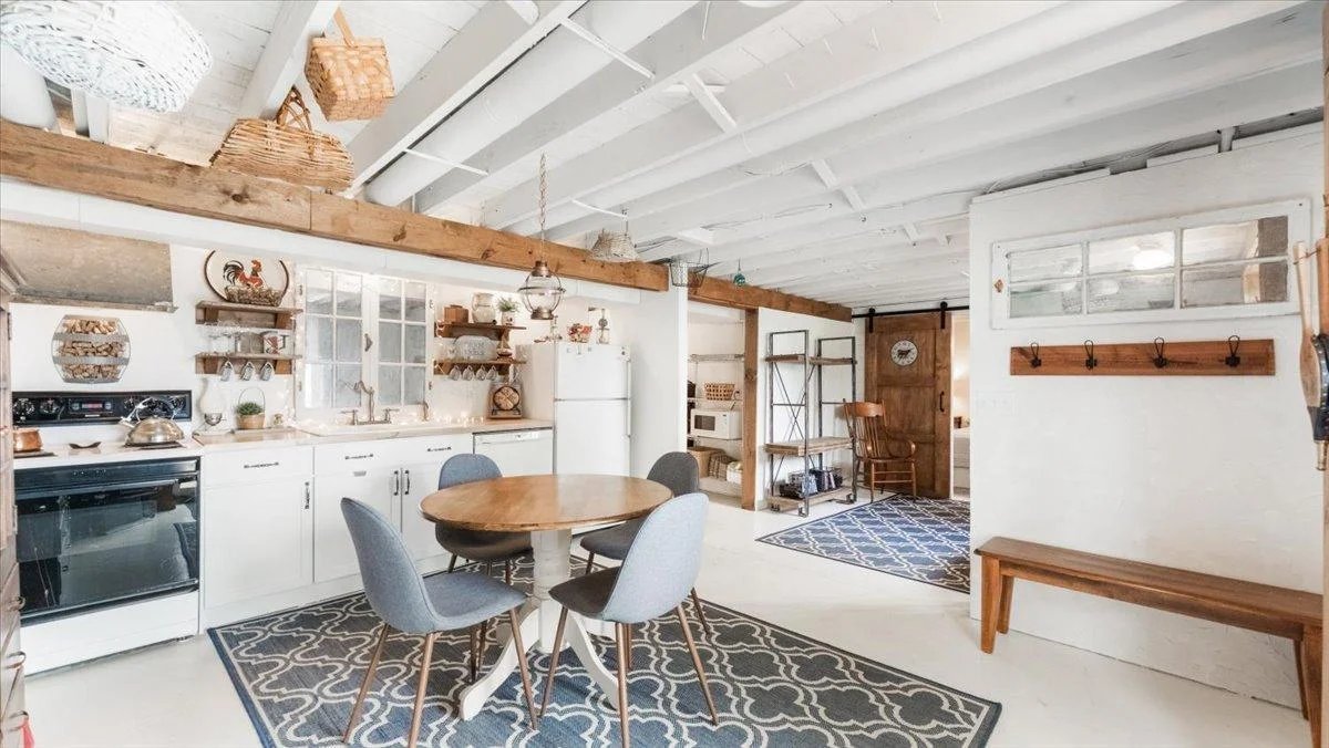The lower level features a kitchenette, a sitting area, and a room currently being used as a non-conforming bedroom.