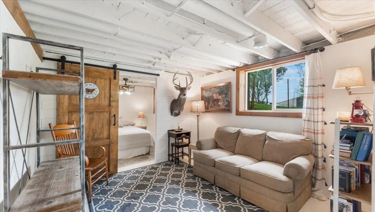 Lower Level features a sitting area and a room being used as a non-conforming bedroom.