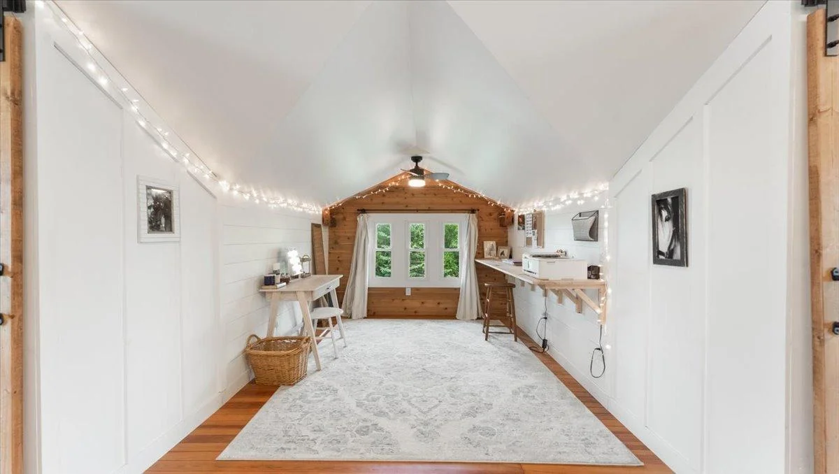 The bedroom features a sitting area with a built-in desk.