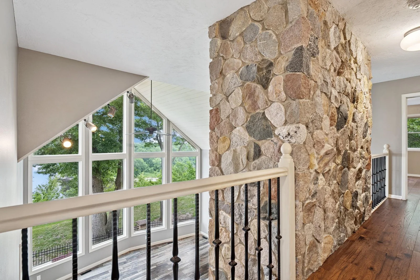 Second floor over looks the wall of windows in the living room