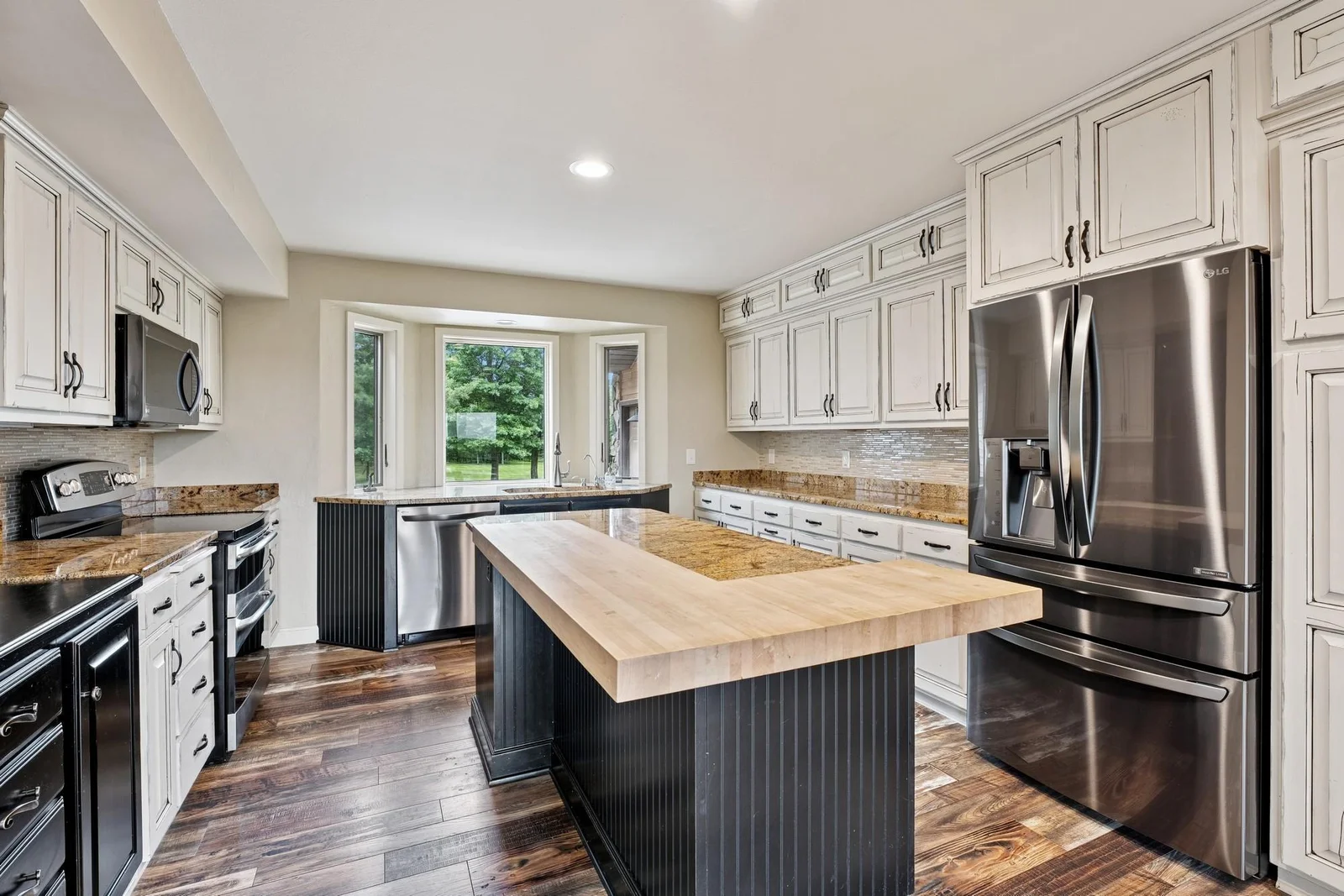 Kitchen sink is located in the bay window overlooking the private front yard and driveway