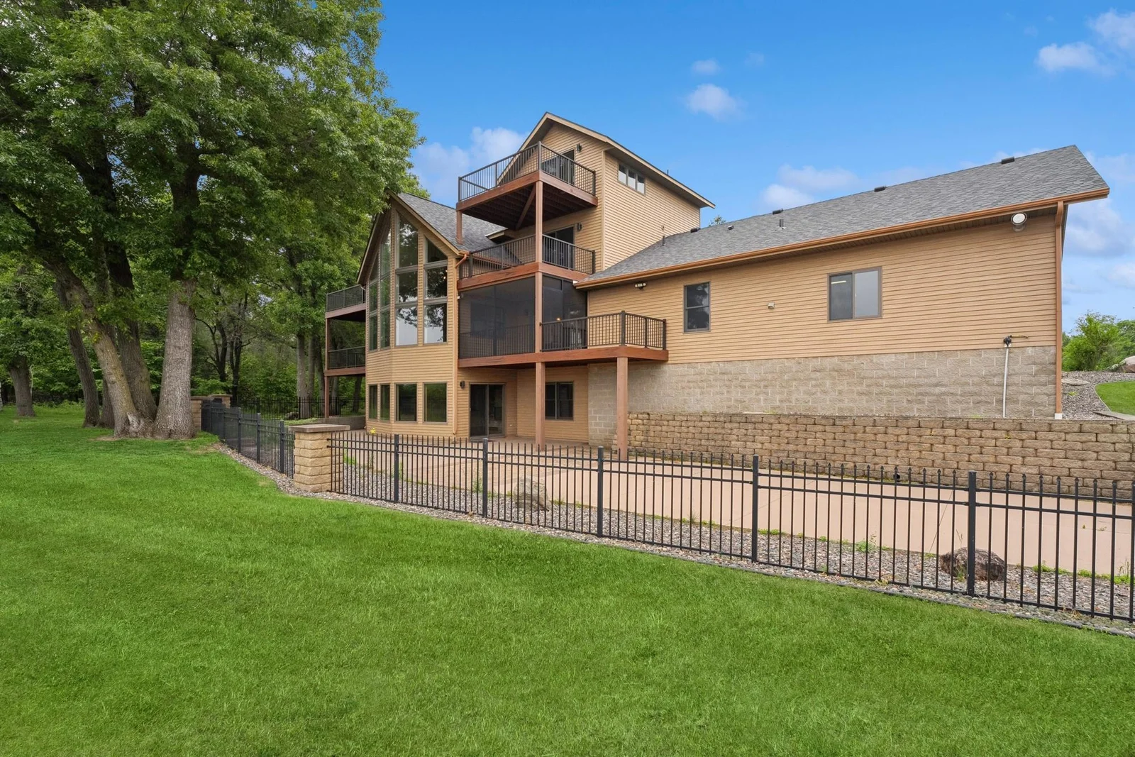 Rear view of home and fenced patio area
