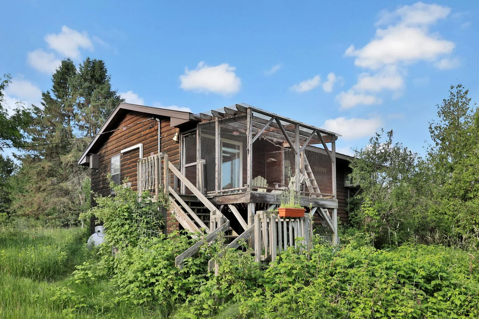 Covered screened deck on the back of the home.
