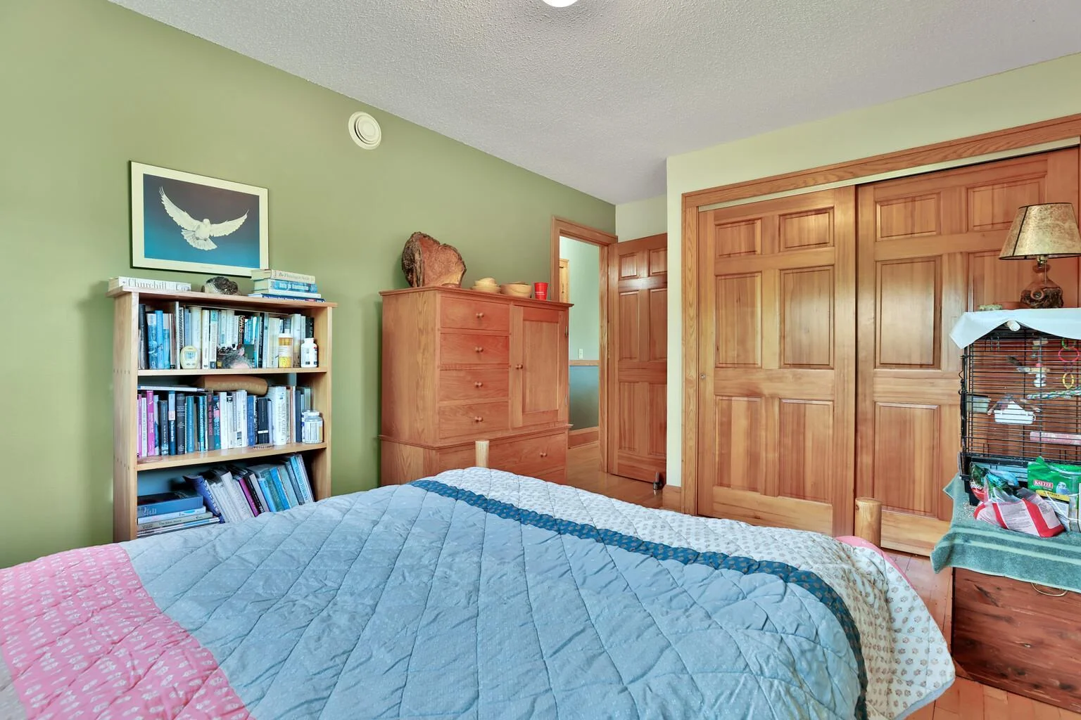 Bedroom one upstairs nice paneled wood doors and maple floors.
