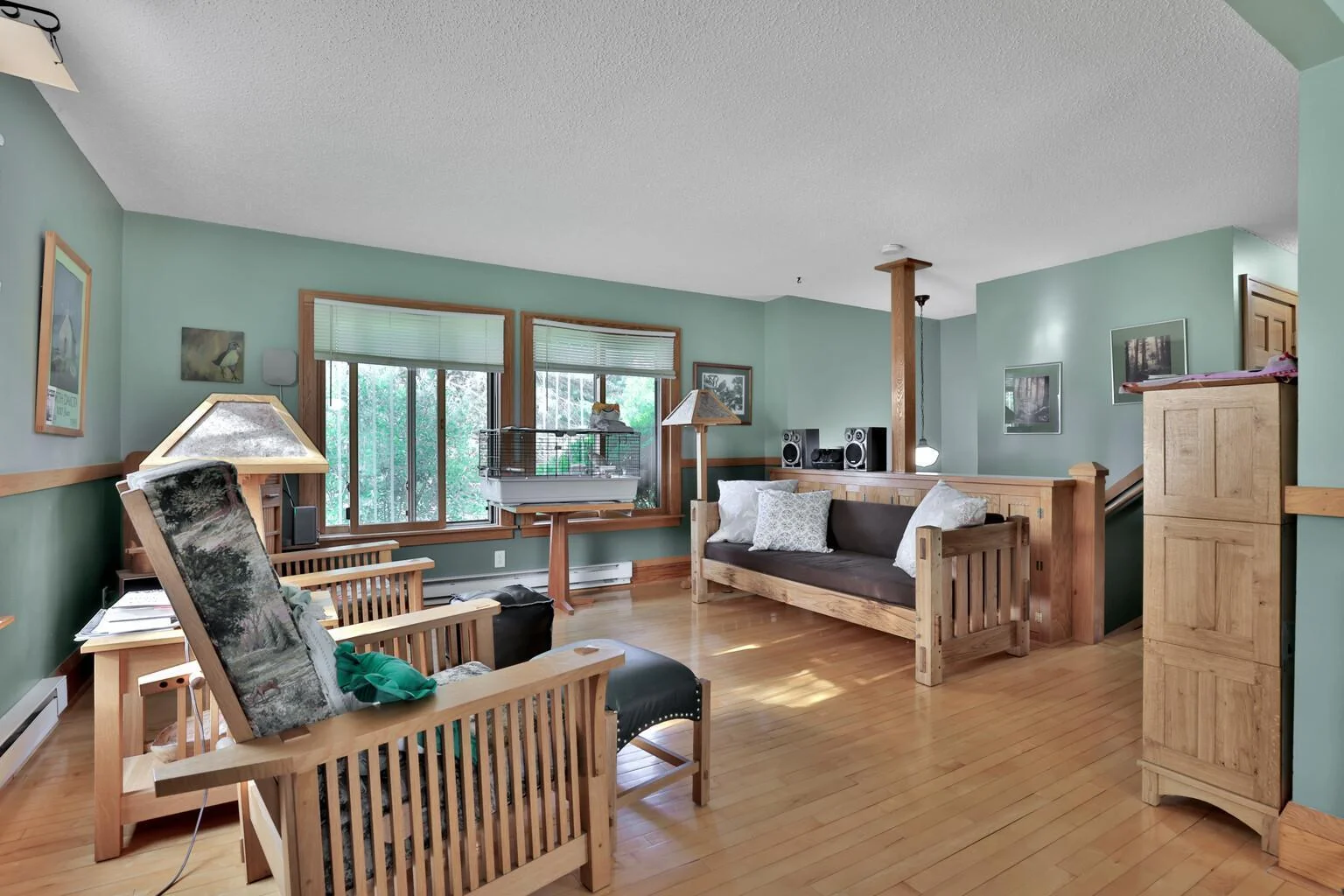 Maple flooring, built in cabinets along the stair wall.