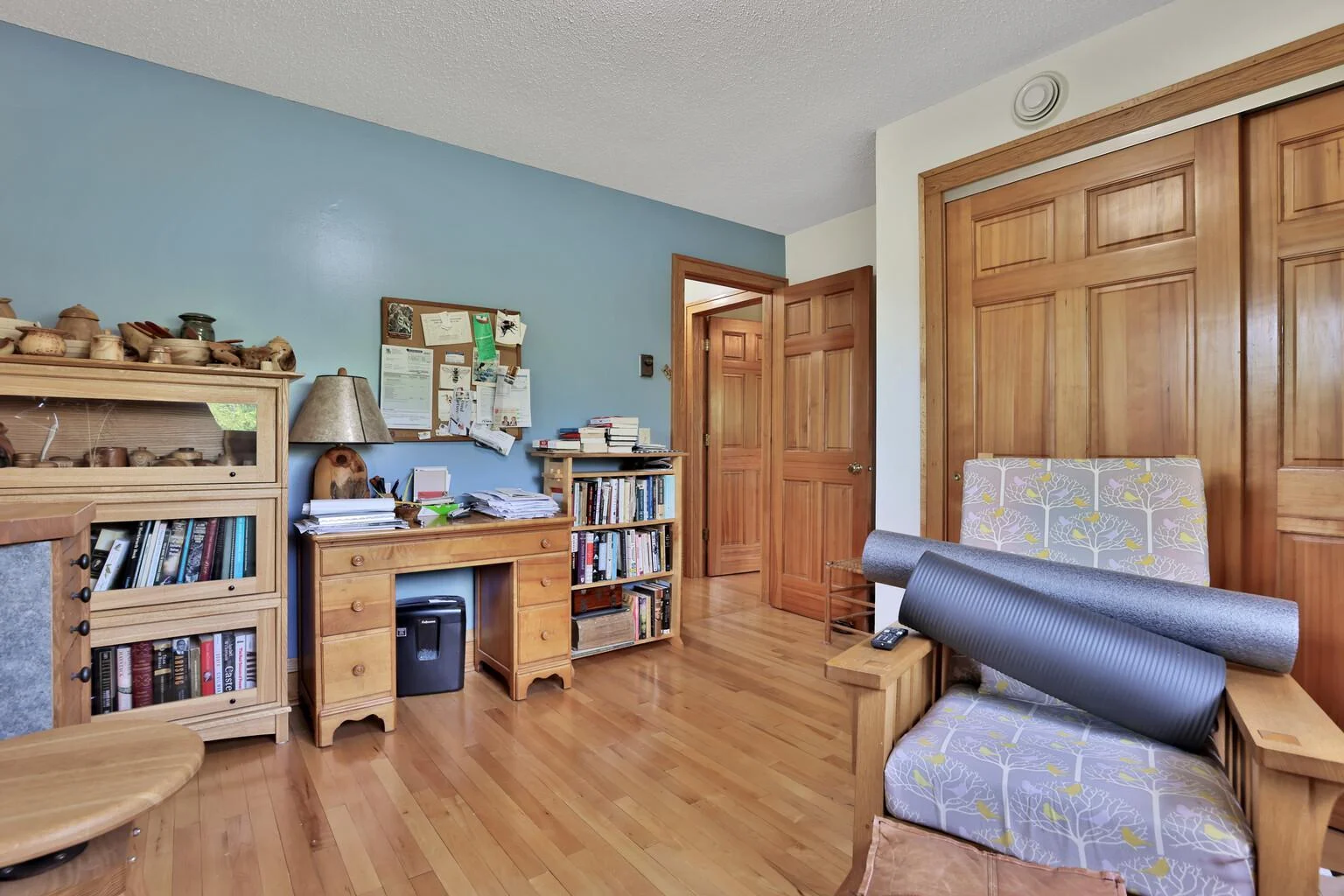 Bedroom 2 on upper level, maple floor and paneled doors.