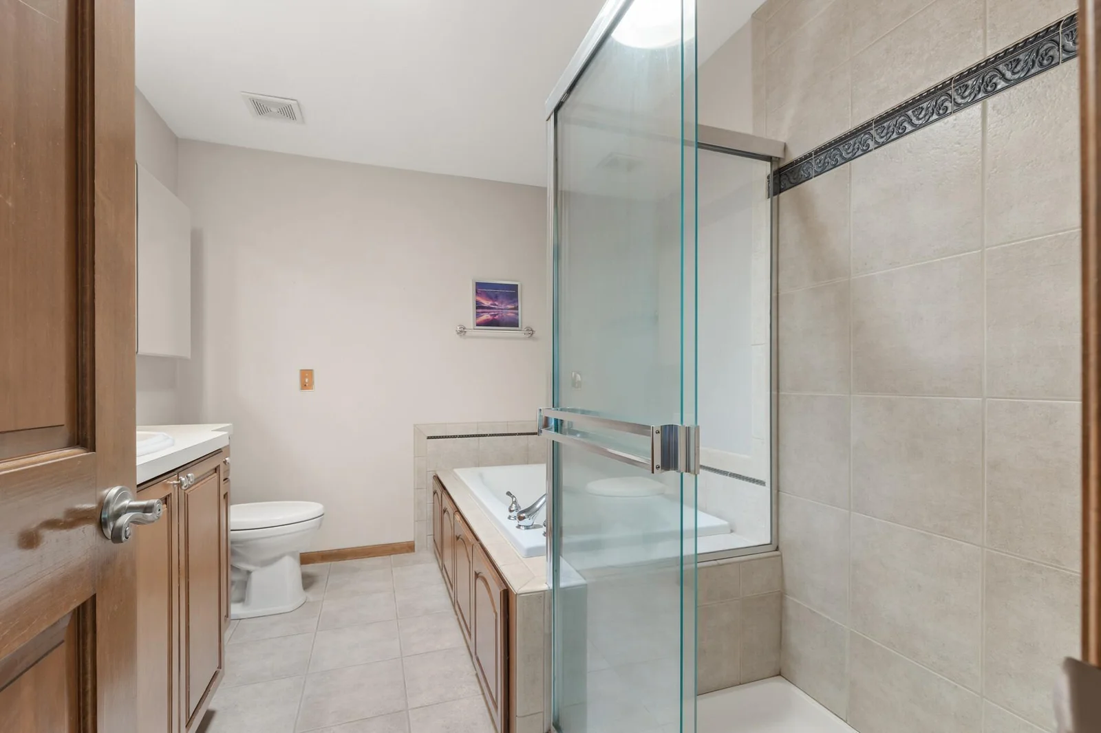 Primary bathroom with walk in shower and jetted tub.