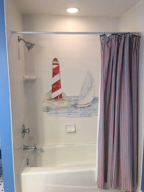 Beautifully hand painted shower tile in guest bedroom ensuite on upper level.!