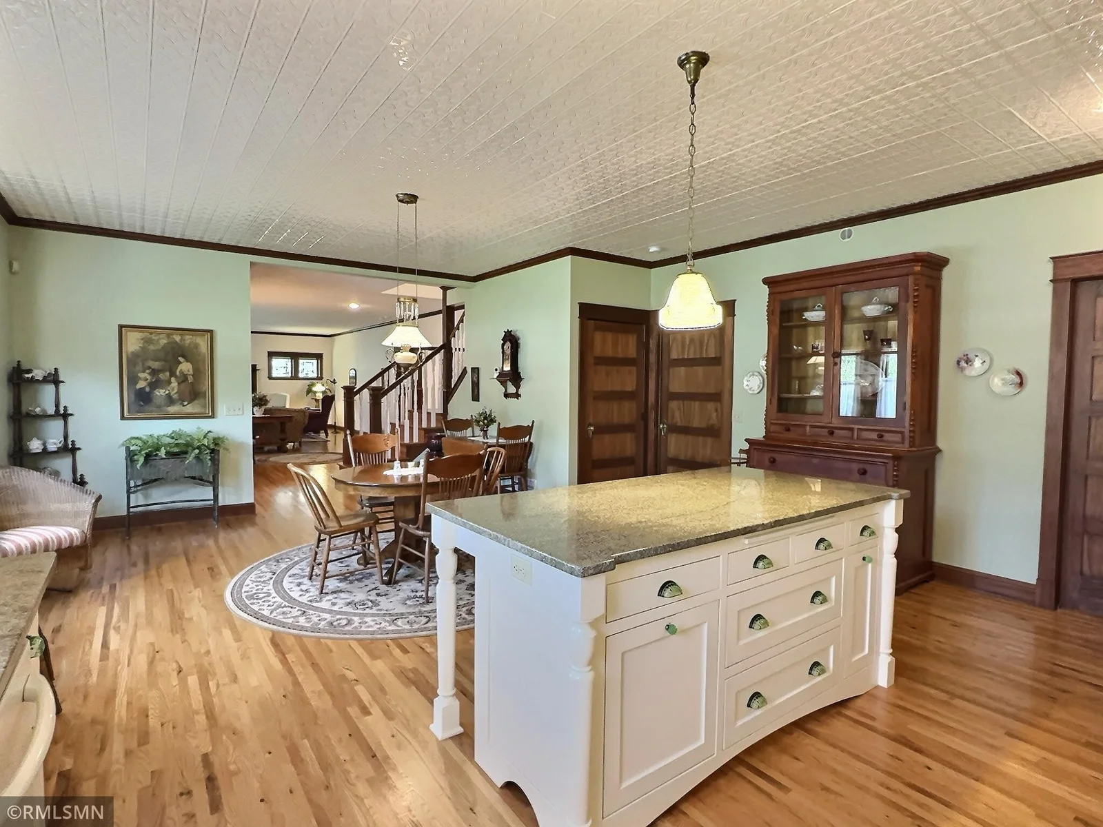 A stunning custom center island with granite countertops provides the perfect spot for prepping meals or gathering with guests.