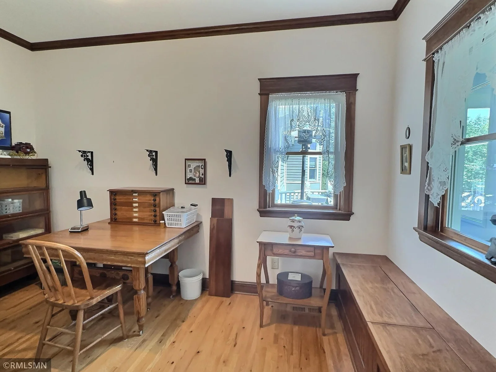 This cozy main-level office is rich in warmth and character, featuring hardwood floors, classic millwork, and vintage-style trim.