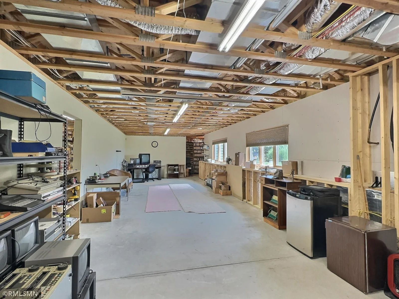 With exposed beams, ample lighting, and tons of storage space, the lower level is ready for both immediate use and future expansion.