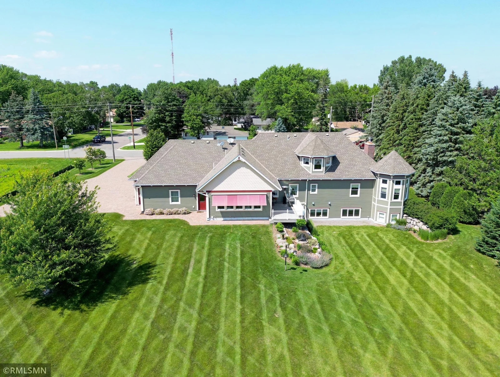 Eye-catching curb appeal welcomes you with a turreted façade, dormer windows, and a large backyard with a pristine lawn.