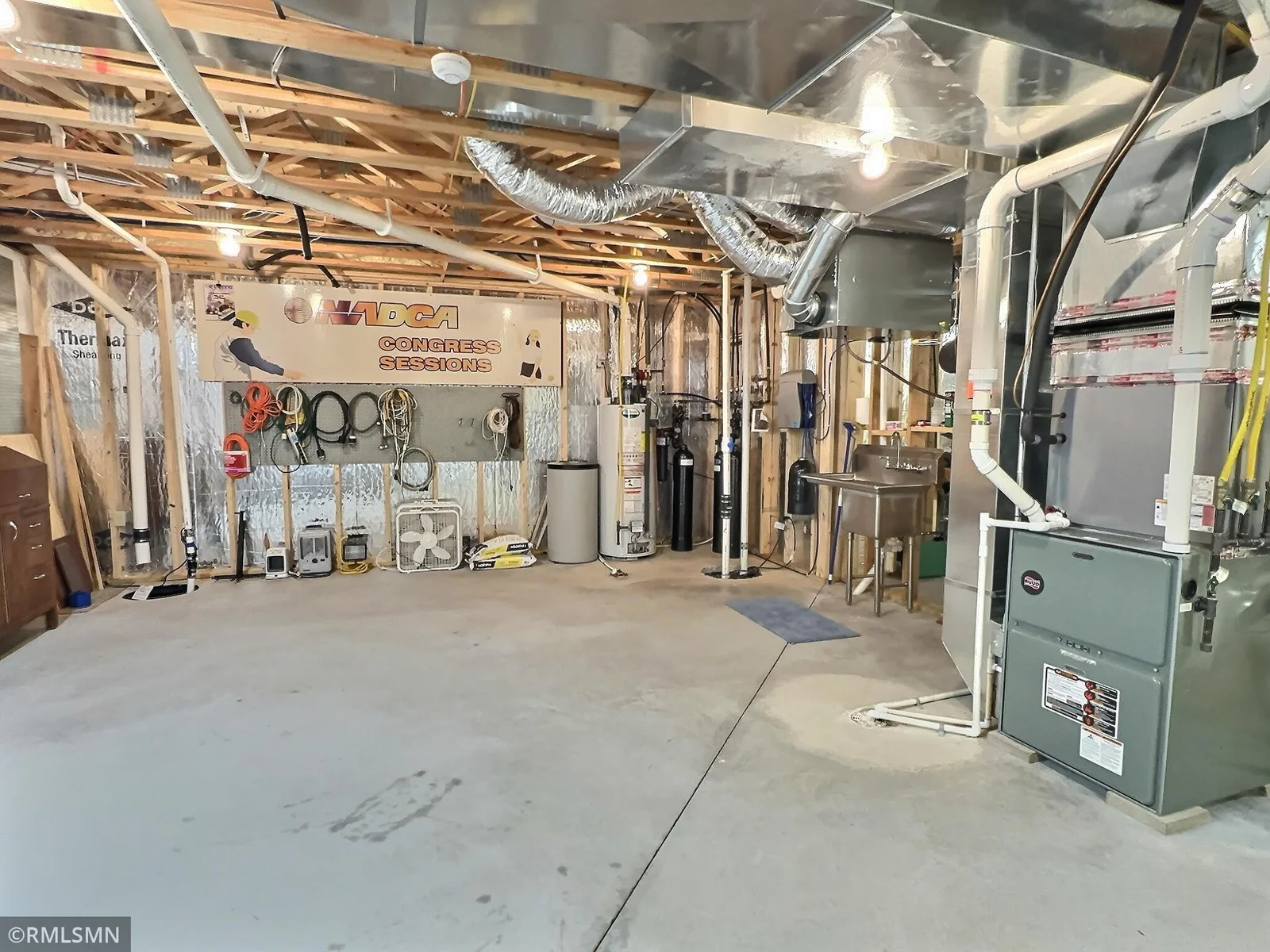 This spacious basement utility area is thoughtfully equipped with a utility sink, and a state-of-the-art water filtration system.