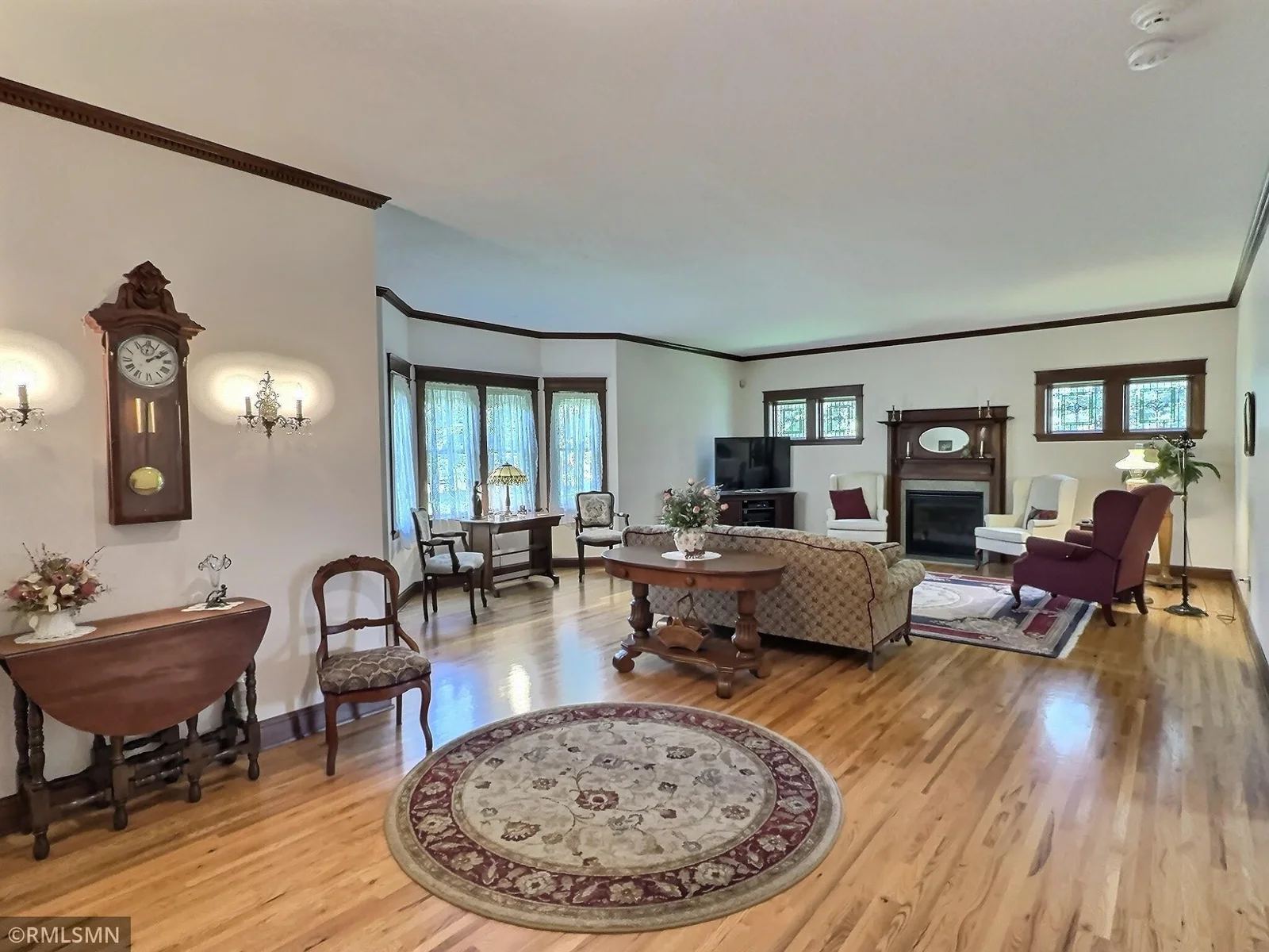 This elegant sitting area gracefully transitions into the inviting living room, creating a seamless flow for both everyday living and entertaining.