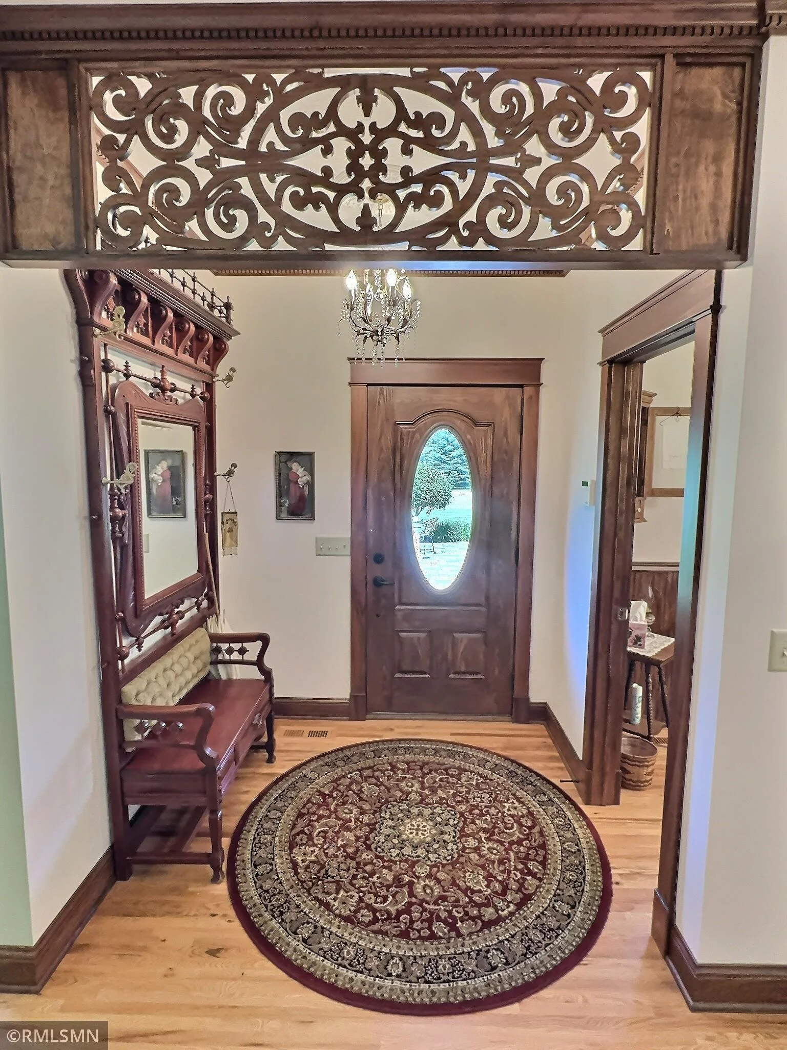 A stunning foyer with carved wood transom sets the tone with vintage sophistication, while rich millwork provide a classic backdrop.