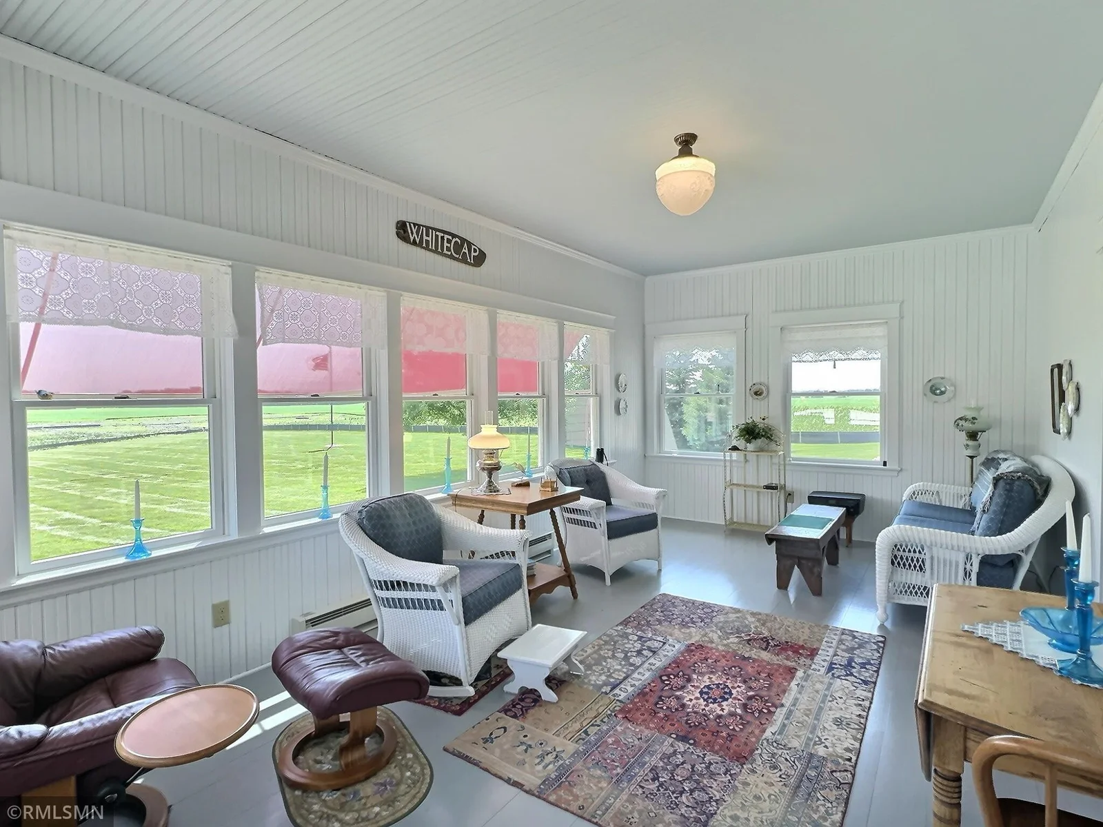 Accented with beadboard walls and ceiling, this bright and inviting space is perfect for morning coffee, or evening conversation.
