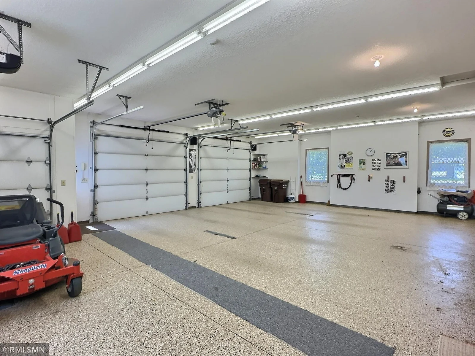 With ample space for storage & equipment, plus bright overhead lighting and multiple access points, this garage offers exceptional functionality.