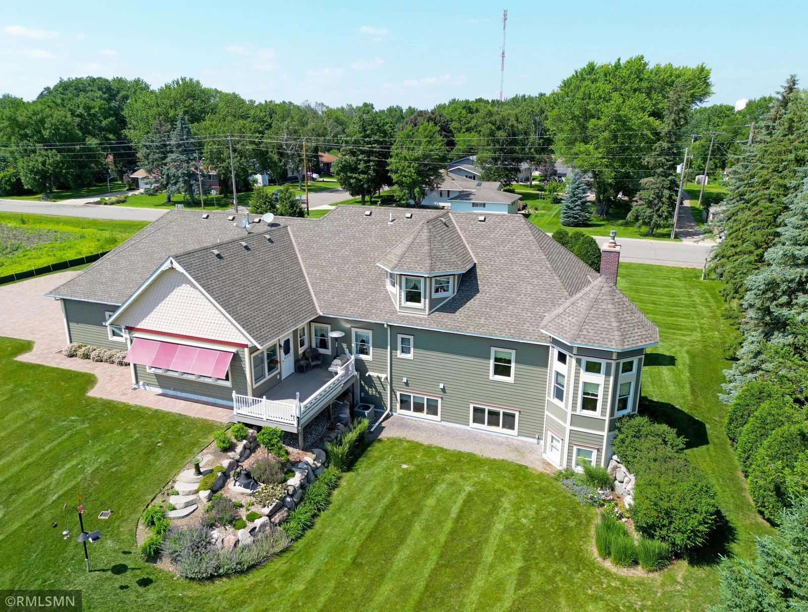 This stunning aerial view showcases the home's striking Victorian-inspired architecture, complete with turreted features and decorative trim.