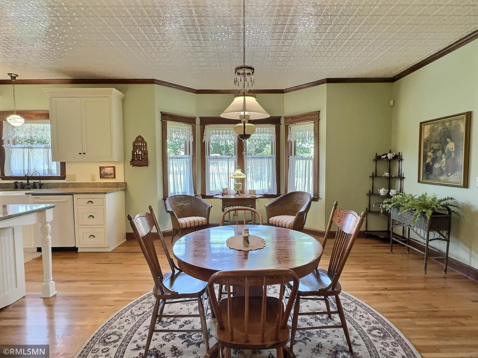 This delightful dining area is surrounded by a trio of large bay windows that fill the attractive space with natural light and elegance.