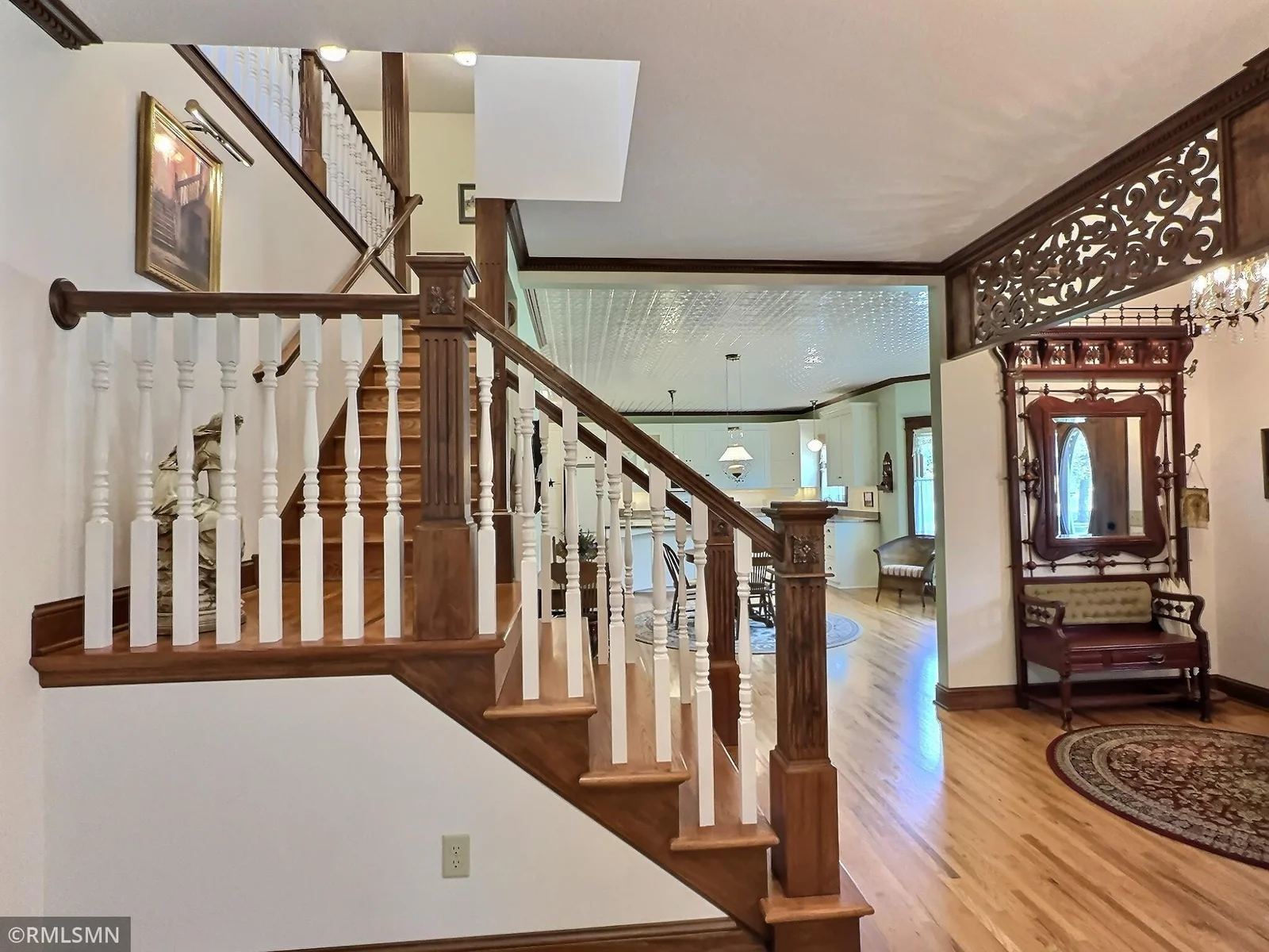 This beautifully crafted staircase is a centerpiece of the home, leading to the upper-level family room with grace and style.