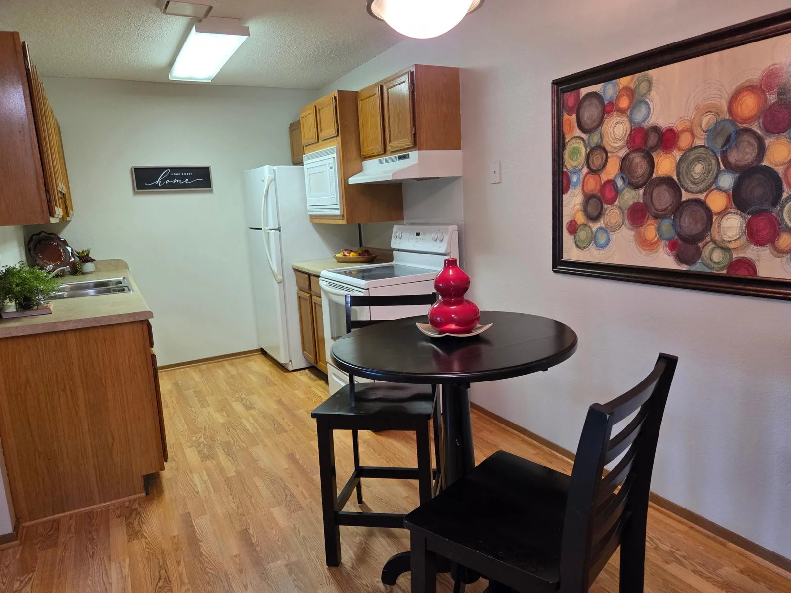 The laminate flooring continues  into the kitchen with ample cabinetry