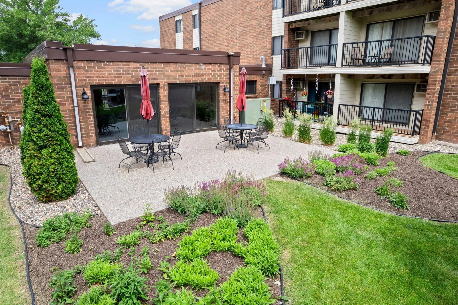drone shot of the lovely outdoor common patio and garden area.