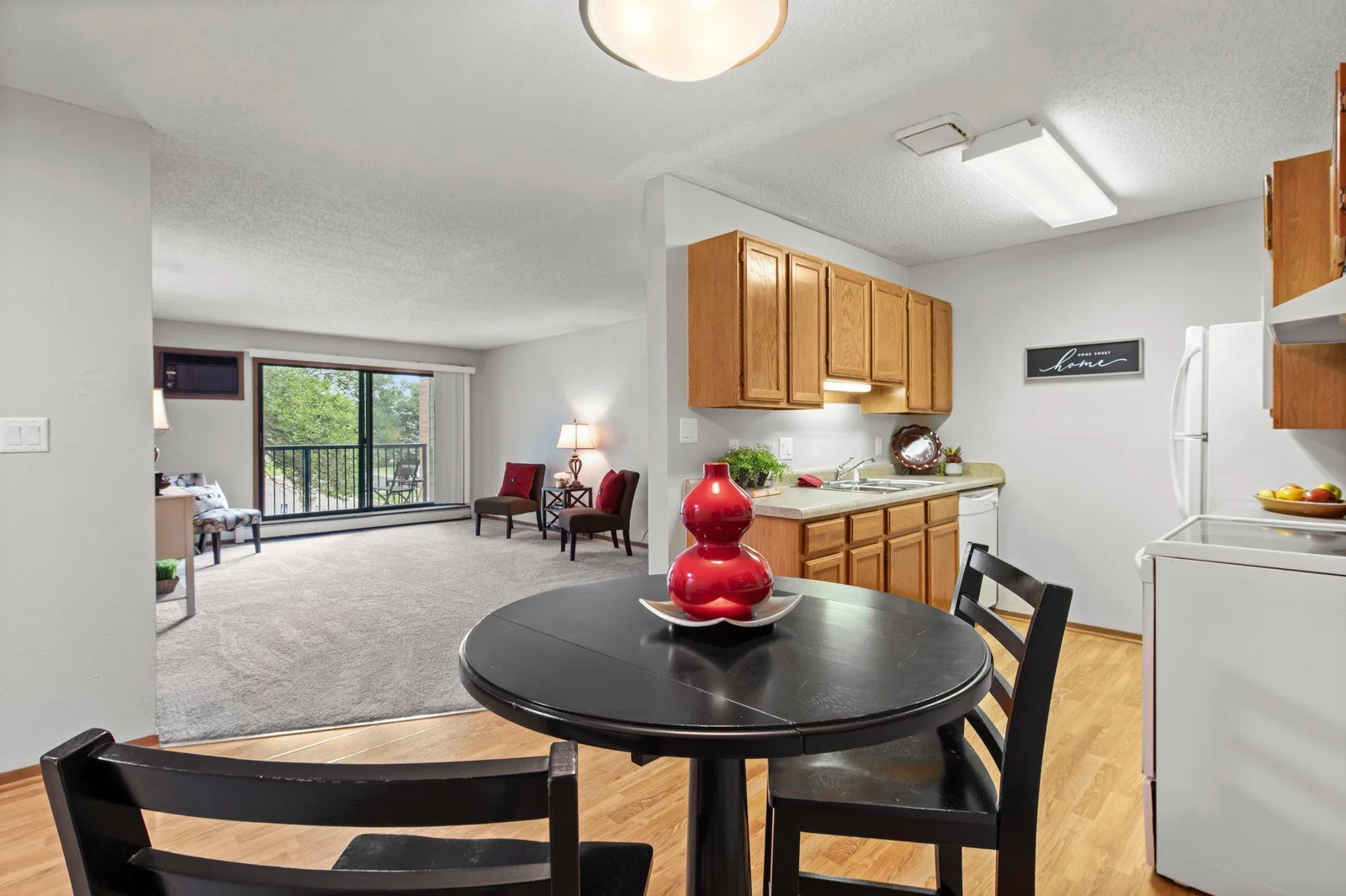 The lovely flooring continues  into the kitchen with ample cabinetry