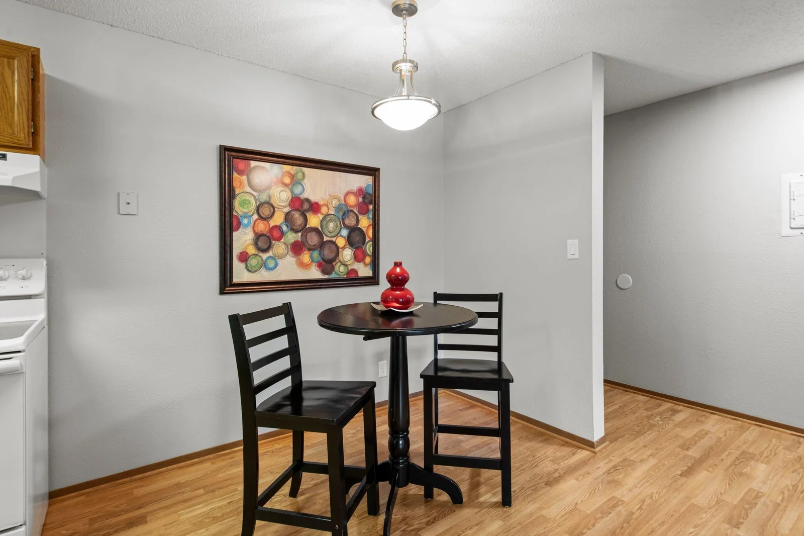 Laminate flooring in the dining room and a new light fixture make this bright and easy to care for