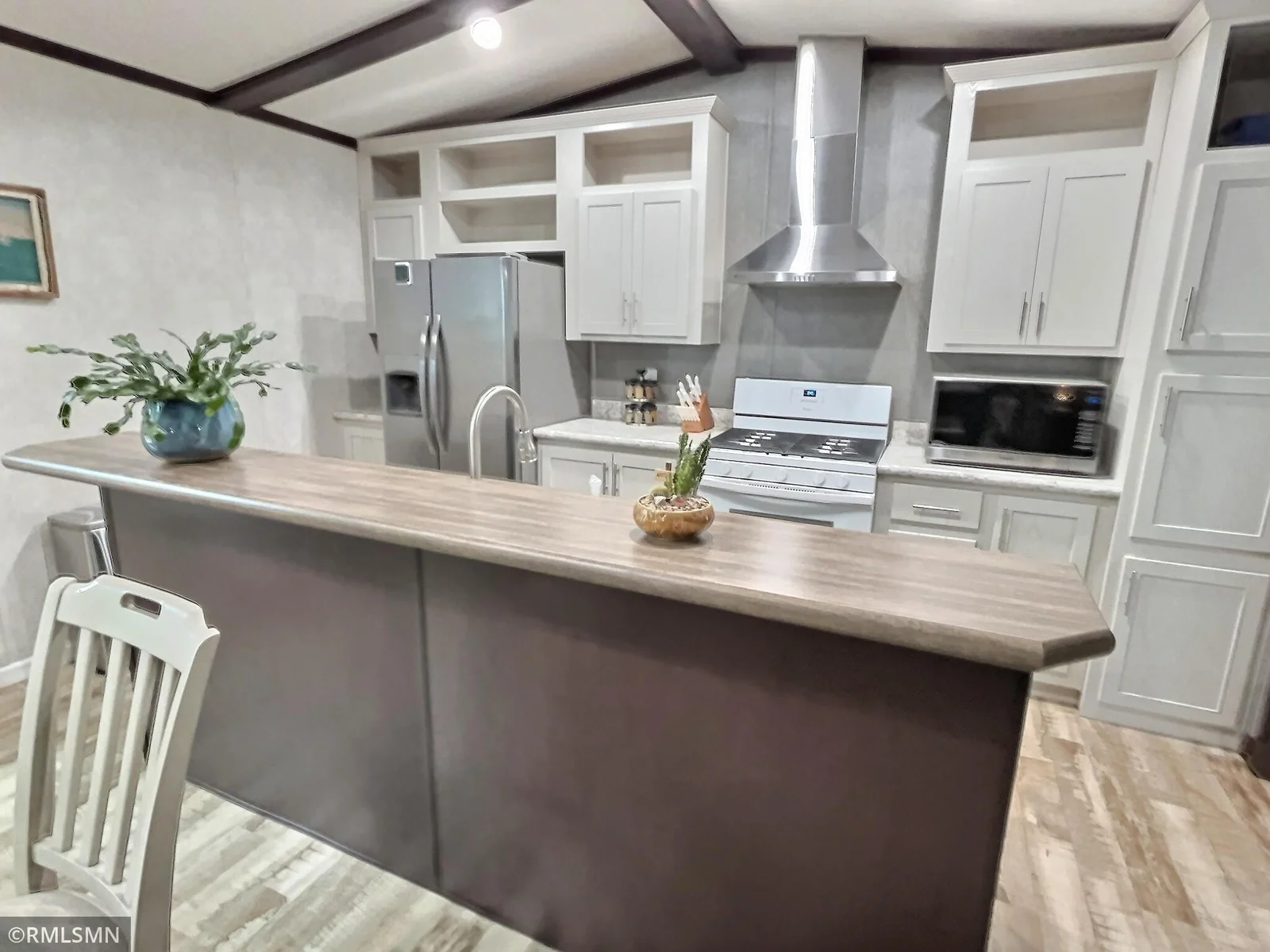 This Kitchen feature a center island with great storage space and modern appliances.